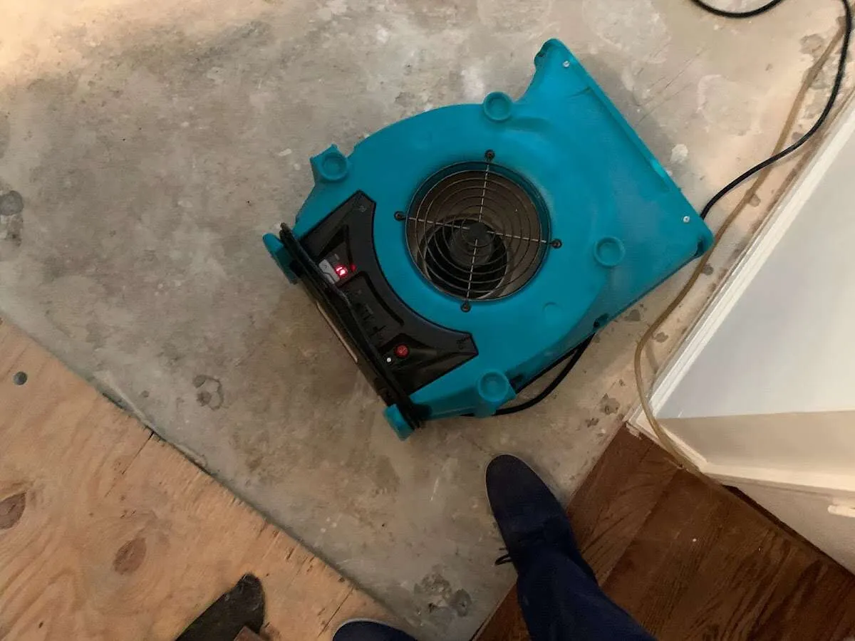 Air mover drying subfloor during Commercial Water Damage Restoration in Riverdale